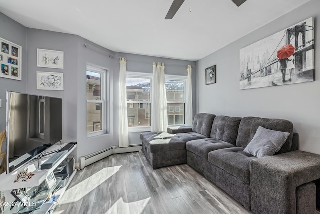 living room with hardwood / wood-style floors, a baseboard radiator, and ceiling fan