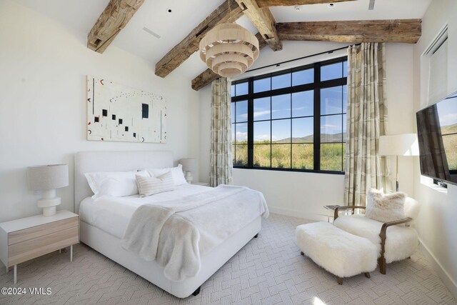 bedroom featuring light carpet and vaulted ceiling with beams