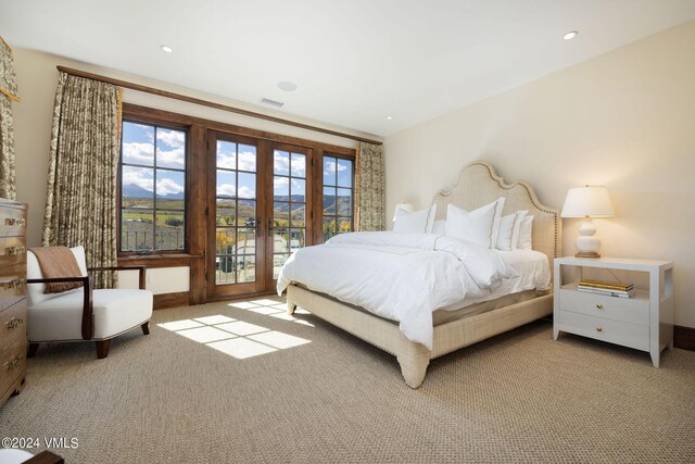 bedroom featuring french doors, access to exterior, and light carpet