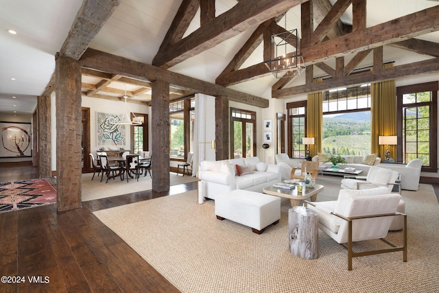 living room featuring hardwood / wood-style flooring, high vaulted ceiling, an inviting chandelier, and beam ceiling