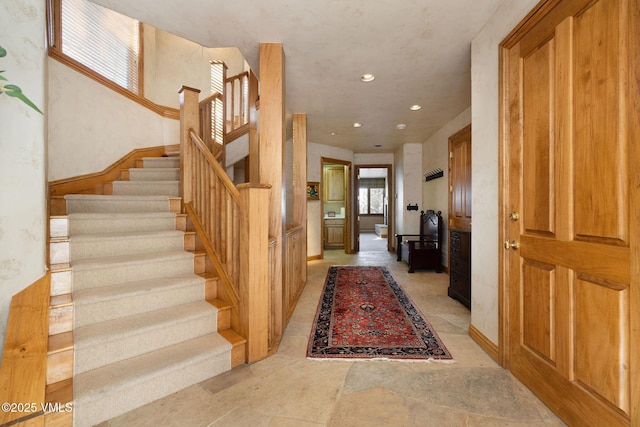 entrance foyer with stairway and recessed lighting