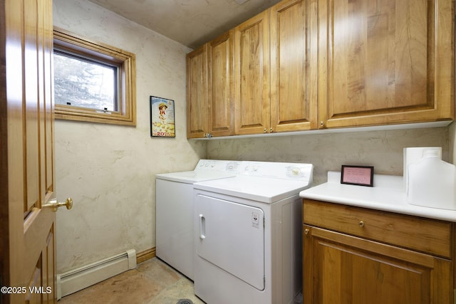 clothes washing area with a baseboard heating unit, independent washer and dryer, cabinet space, and baseboards