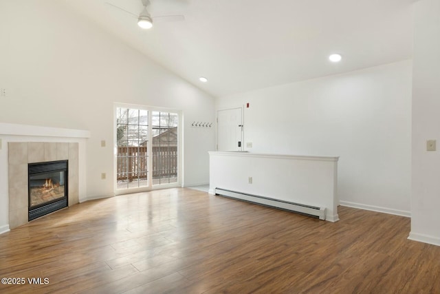 unfurnished living room with a tiled fireplace, wood finished floors, ceiling fan, and a baseboard radiator