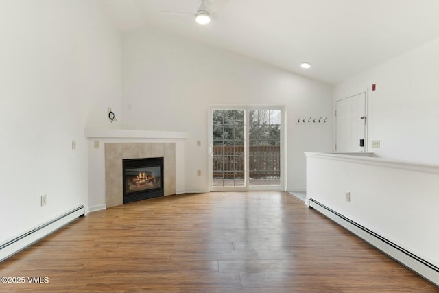 unfurnished living room with vaulted ceiling, wood finished floors, and a baseboard radiator