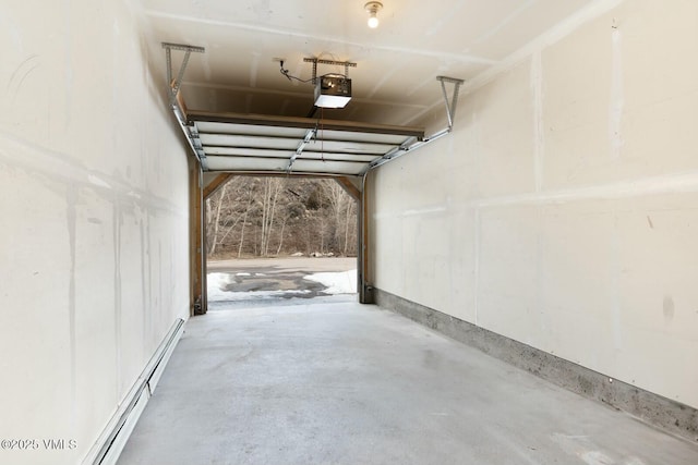 garage featuring a garage door opener and a baseboard heating unit