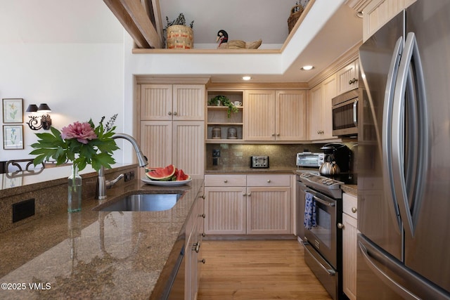 111 Scott Hill Rd Unit 17, Beaver Creek, CO 81620 - kitchen with appliances with stainless steel finishes, tasteful backsplash, open shelves, light wood-type flooring, and dark stone counters
