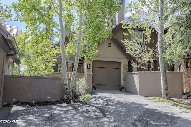111 Scott Hill Rd Unit 17, Beaver Creek, CO 81620 - view of property exterior featuring asphalt driveway, stucco siding, and stone siding