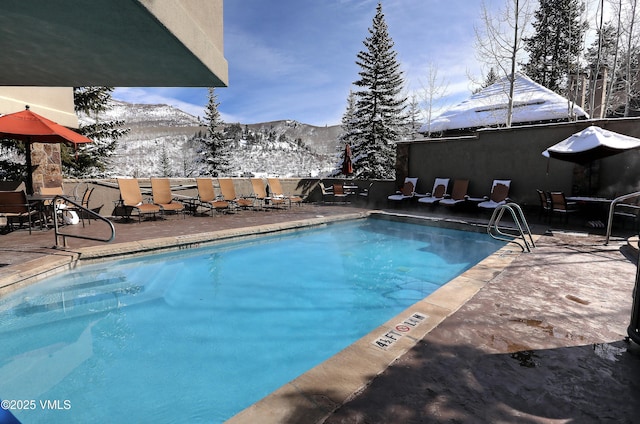111 Scott Hill Rd Unit 17, Beaver Creek, CO 81620 - snow covered pool with a mountain view, a community pool, and a patio area