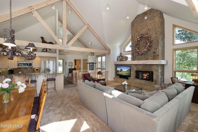 111 Scott Hill Rd Unit 17, Beaver Creek, CO 81620 - living room featuring high vaulted ceiling, a large fireplace, a chandelier, and light colored carpet