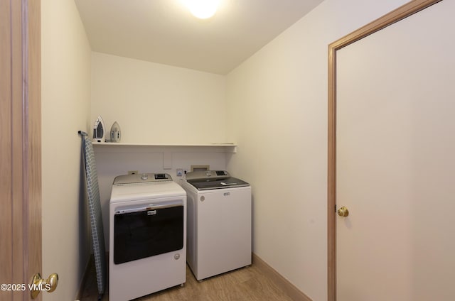 111 Scott Hill Rd Unit 17, Beaver Creek, CO 81620 - washroom featuring washer and clothes dryer and light wood finished floors