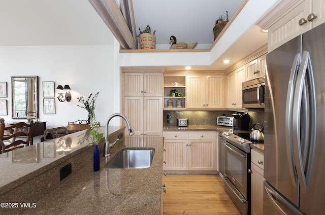 111 Scott Hill Rd Unit 17, Beaver Creek, CO 81620 - kitchen featuring appliances with stainless steel finishes, a sink, open shelves, backsplash, and light wood-style floors
