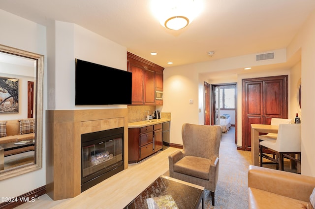 living room with light wood-type flooring and a fireplace