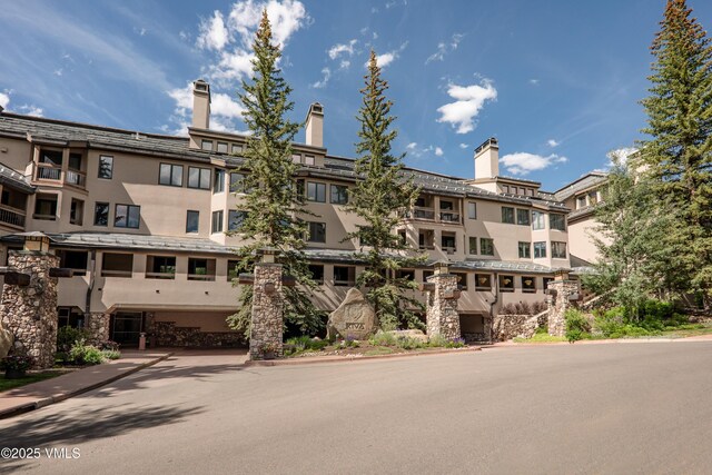 311 Offerson Rd Unit 223, Beaver Creek, CO 81620 - view of patio with an outdoor stone fireplace