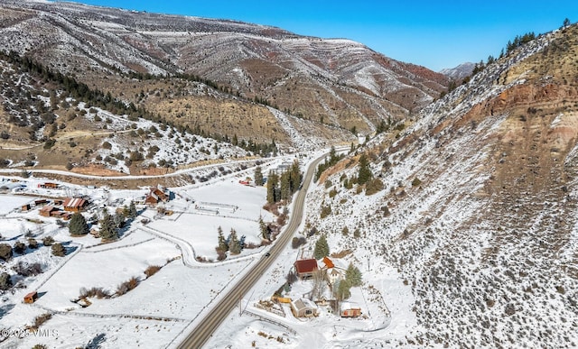 snowy aerial view with a mountain view