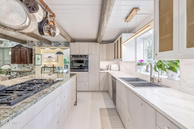 kitchen featuring tasteful backsplash, sink, light stone counters, stainless steel appliances, and beam ceiling