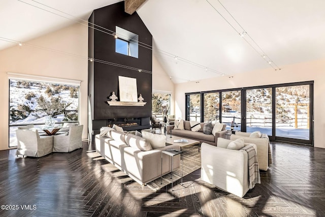 living room featuring beamed ceiling, a large fireplace, high vaulted ceiling, and dark parquet floors