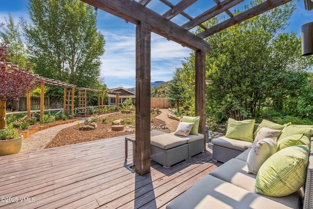 wooden deck with an outdoor living space and a pergola