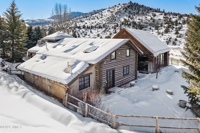 snowy aerial view featuring a mountain view