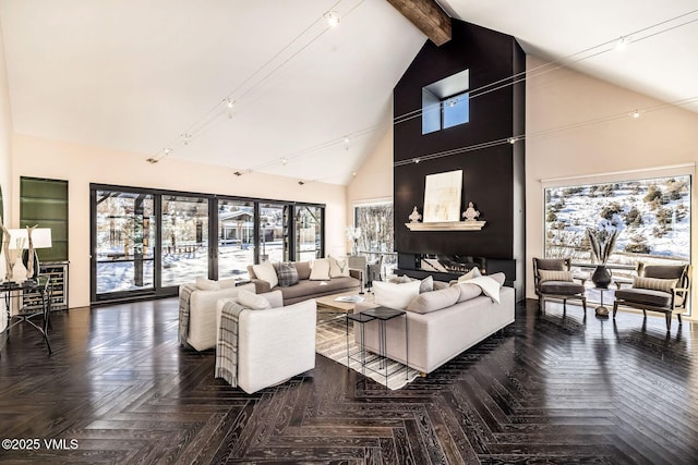 living room with dark parquet flooring, high vaulted ceiling, rail lighting, and beamed ceiling