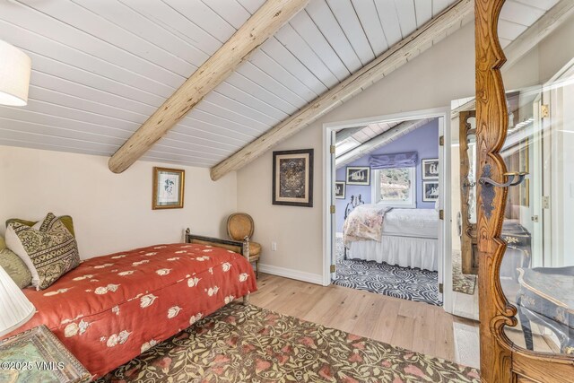 bedroom with hardwood / wood-style flooring, vaulted ceiling with beams, and wood ceiling