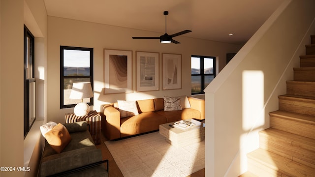 living room with light hardwood / wood-style flooring and ceiling fan