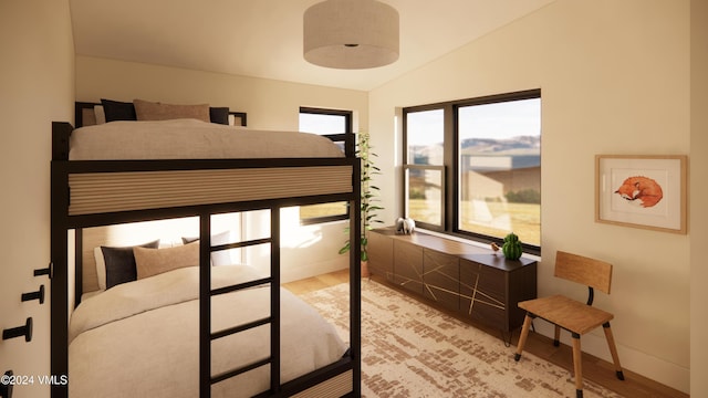 bedroom featuring vaulted ceiling and wood-type flooring