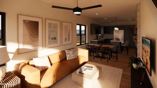 living room with ceiling fan and light hardwood / wood-style floors