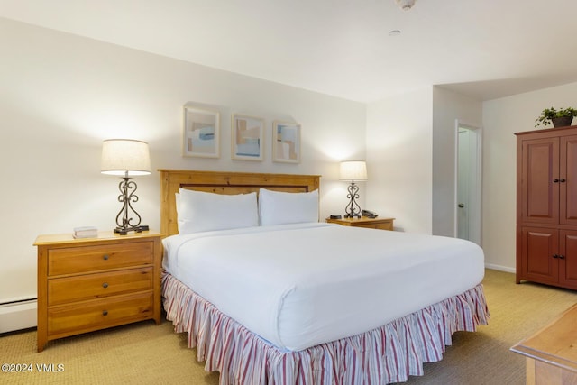 bedroom with light carpet and a baseboard radiator