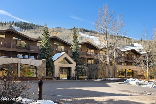 snow covered property featuring a mountain view