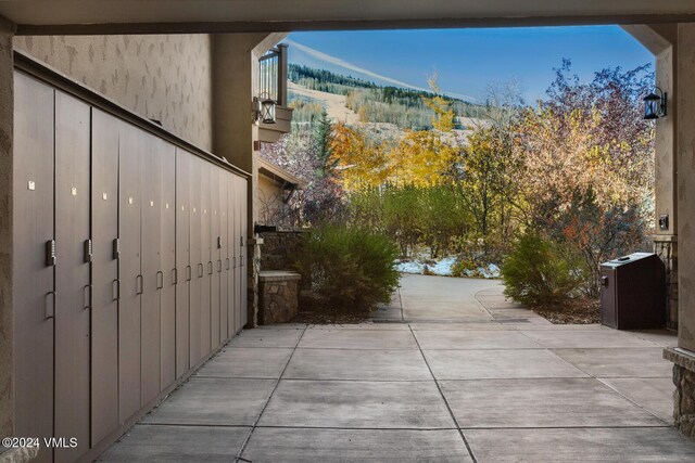 view of side of property featuring a patio and a mountain view