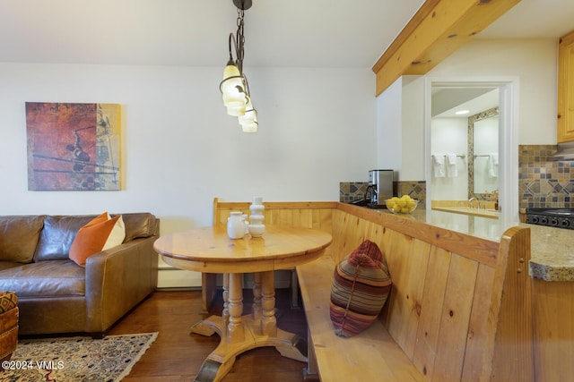 dining room with a baseboard heating unit and hardwood / wood-style flooring