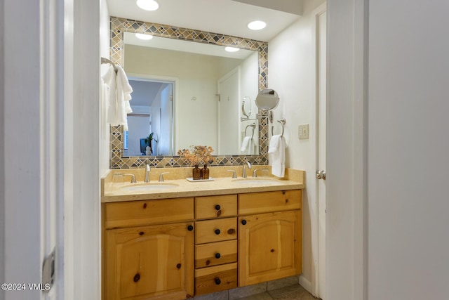 bathroom with vanity and decorative backsplash