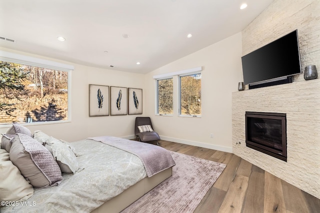 3235 Katsos Ranch Rd, Vail, CO 81657 - bedroom with recessed lighting, wood finished floors, vaulted ceiling, and a fireplace