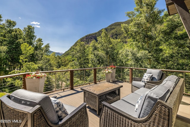 3235 Katsos Ranch Rd, Vail, CO 81657 - deck with a mountain view, a view of trees, and an outdoor hangout area