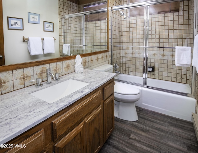 760 W Beaver Creek Blvd Unit 115, Avon, CO 81620 - bathroom featuring vanity, combined bath / shower with glass door, wood finished floors, and decorative backsplash