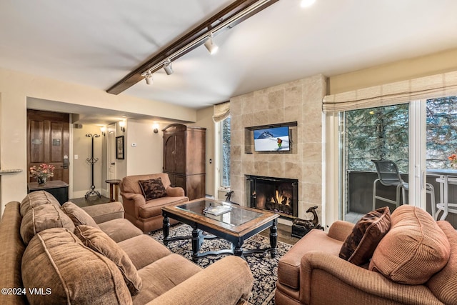 living room featuring track lighting and a tile fireplace