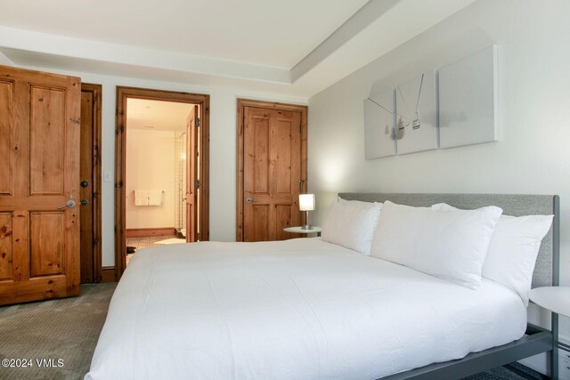 carpeted bedroom featuring connected bathroom