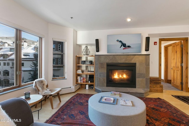 living room featuring light hardwood / wood-style flooring and a high end fireplace