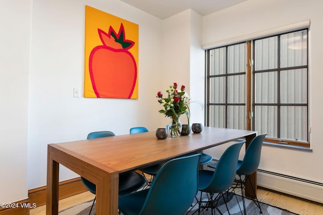 dining room featuring wood-type flooring and a baseboard radiator