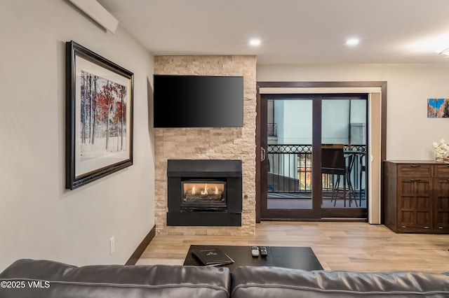 555 E Lionshead Cir Unit 207, Vail, CO 81657 - living area with wood finished floors, recessed lighting, and a stone fireplace