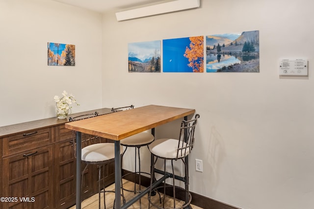 555 E Lionshead Cir Unit 207, Vail, CO 81657 - dining space with light wood-type flooring and an AC wall unit
