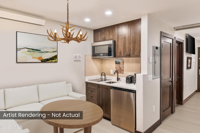 555 E Lionshead Cir Unit 207, Vail, CO 81657 - kitchen with appliances with stainless steel finishes, a chandelier, light countertops, light wood-type flooring, and recessed lighting