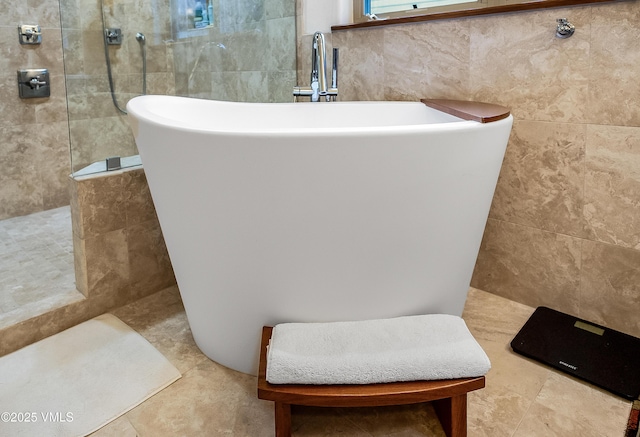 2832 Kinnickinnick Rd Unit 4, Vail, CO 81657 - full bathroom featuring tile walls, a walk in shower, and a freestanding bath