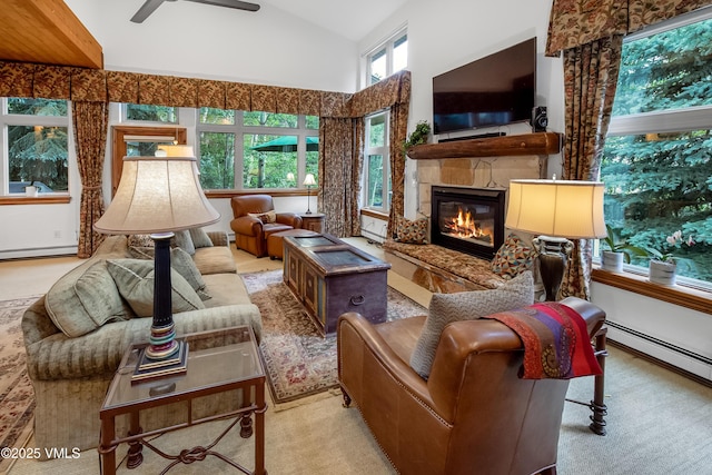 2832 Kinnickinnick Rd Unit 4, Vail, CO 81657 - living room with a ceiling fan, a stone fireplace, a baseboard radiator, carpet floors, and high vaulted ceiling