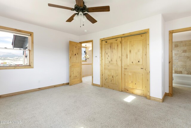 unfurnished bedroom featuring light colored carpet, a closet, and ceiling fan