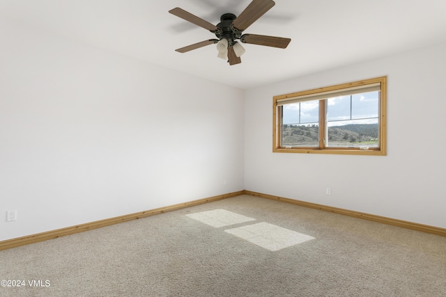 carpeted empty room with ceiling fan