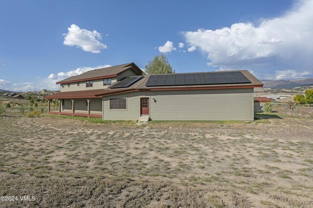 back of property with a mountain view