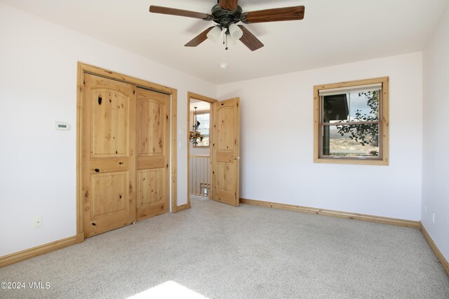 unfurnished bedroom featuring light colored carpet and ceiling fan