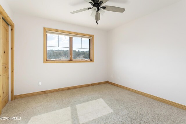 unfurnished bedroom featuring carpet floors and ceiling fan