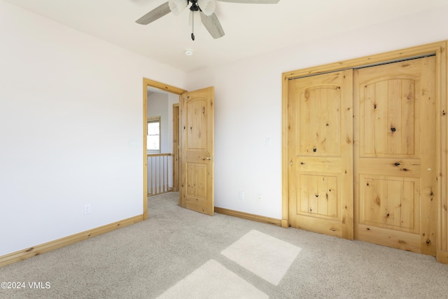 unfurnished bedroom featuring light colored carpet and ceiling fan